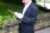 One of our surveyors, John Coppock surveying the entrance to a school.